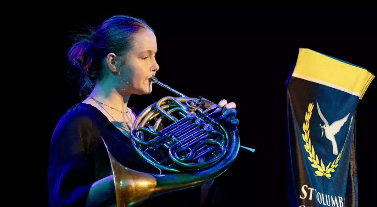 Georgia Hammond playing the French Horn